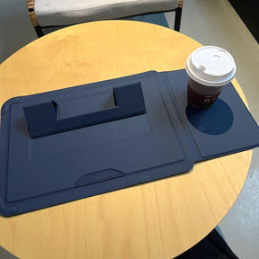 Laptophoes naast een laptop op een bureau